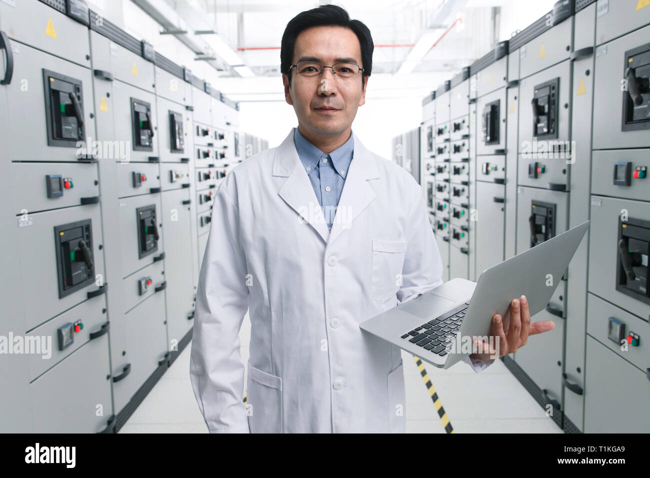 Technical personnel in the voltage room work Stock Photo