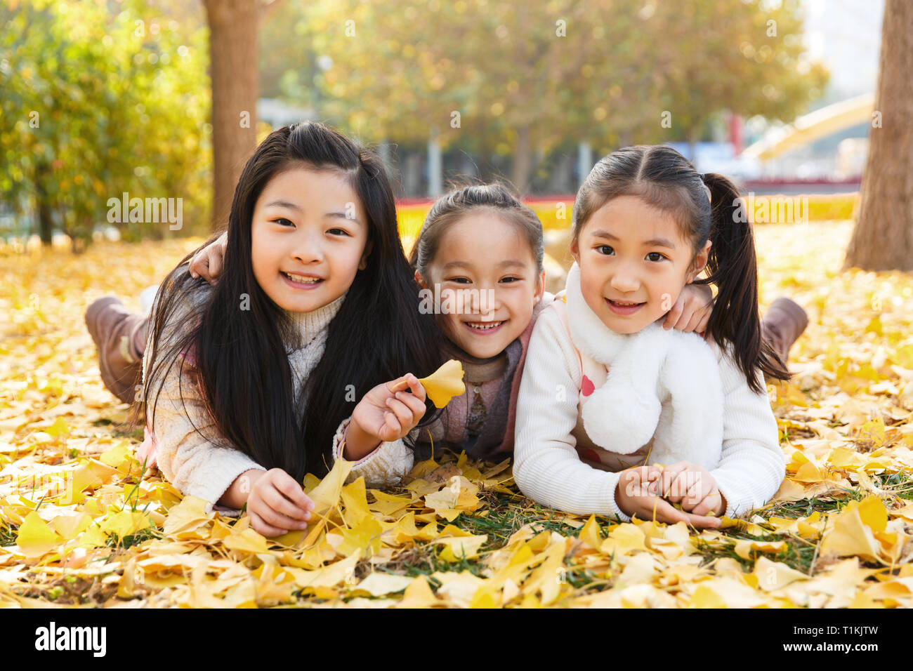 Happy little girl playing outside Stock Photo - Alamy