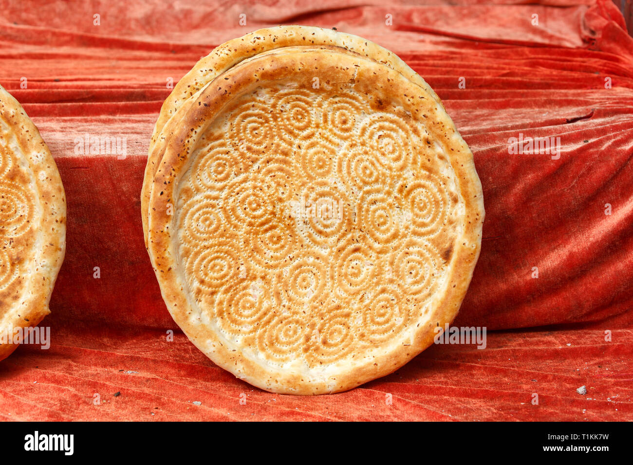 KASHGAR, XINJIANG / CHINA - October 2, 2017: Uighur flat bread on display for sale, waiting to be bought by a hungry customer. Stock Photo