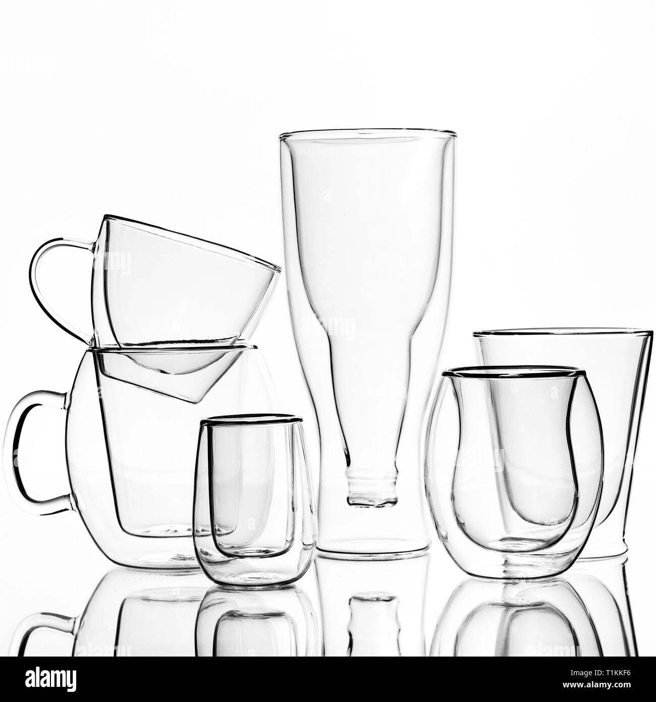 Glasses and cups with double walls, on a white background. Isolated. Stock Photo