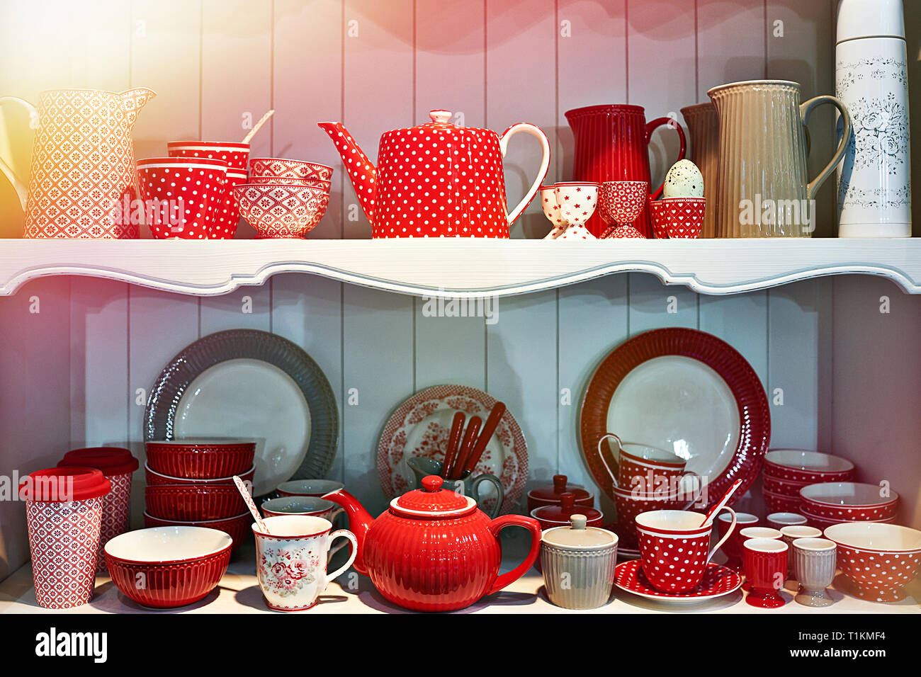Red antique porcelain utensils in the sideboard Stock Photo