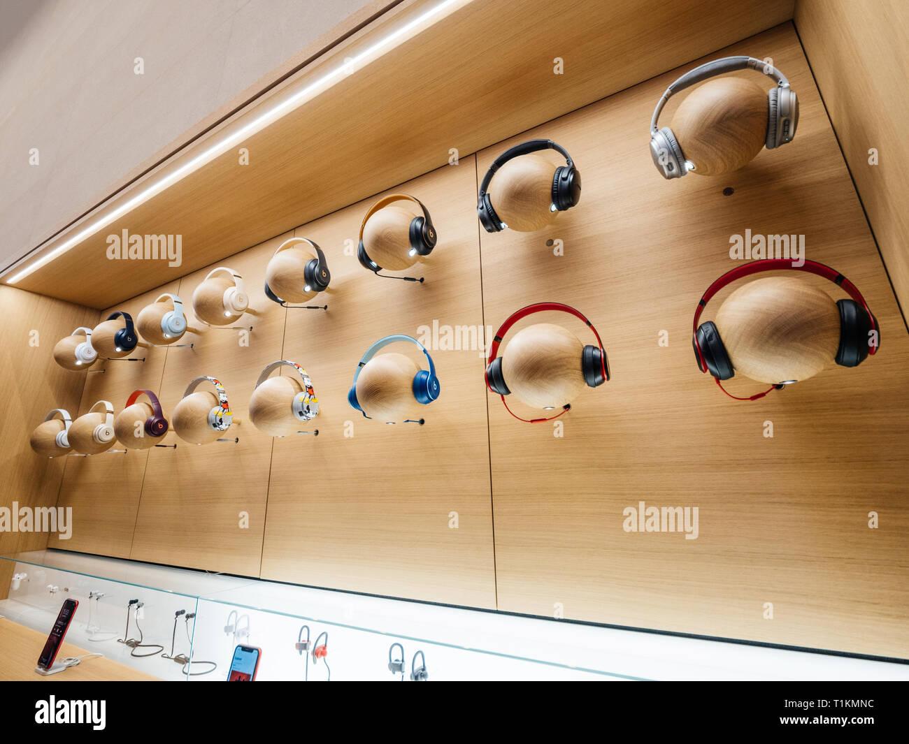 Paris, France - Mar 19 2019: Multiple Audio headphones Beats bu Dr Dre Apple products on mannequin heads are displayed inside the new Apple Store Champs-Elysees  Stock Photo