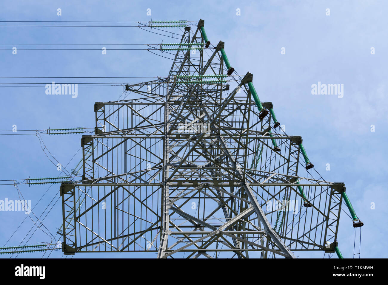 From bottom to top an electric tower with cables Stock Photo