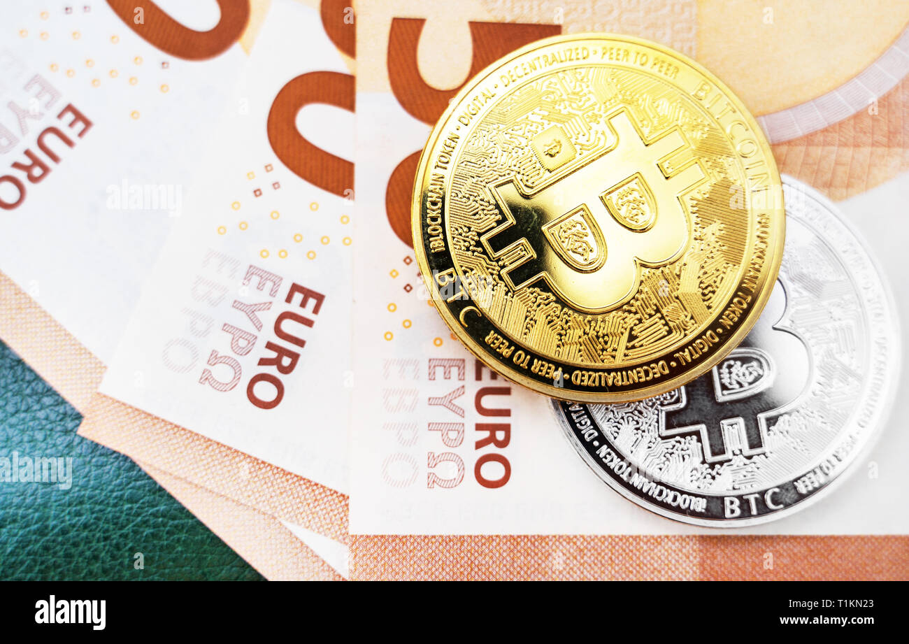 Bitcoin coins cryptocurrency lying on the euro banknotes Stock Photo - Alamy
