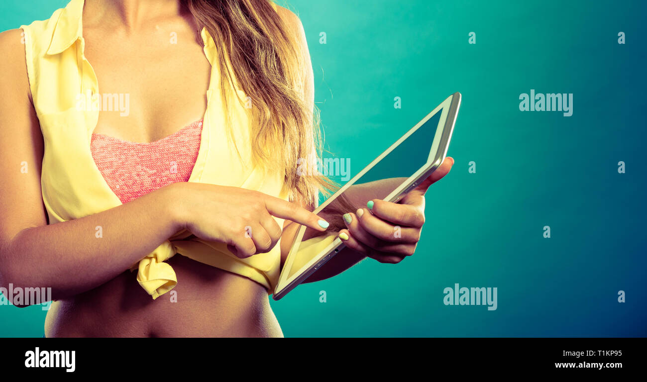 Digital tablet and pin up girl. Attractive pin up lady with tablet. Young  woman wearing yellow tied shirt and pink bra. Female holding IT equipment  Stock Photo - Alamy