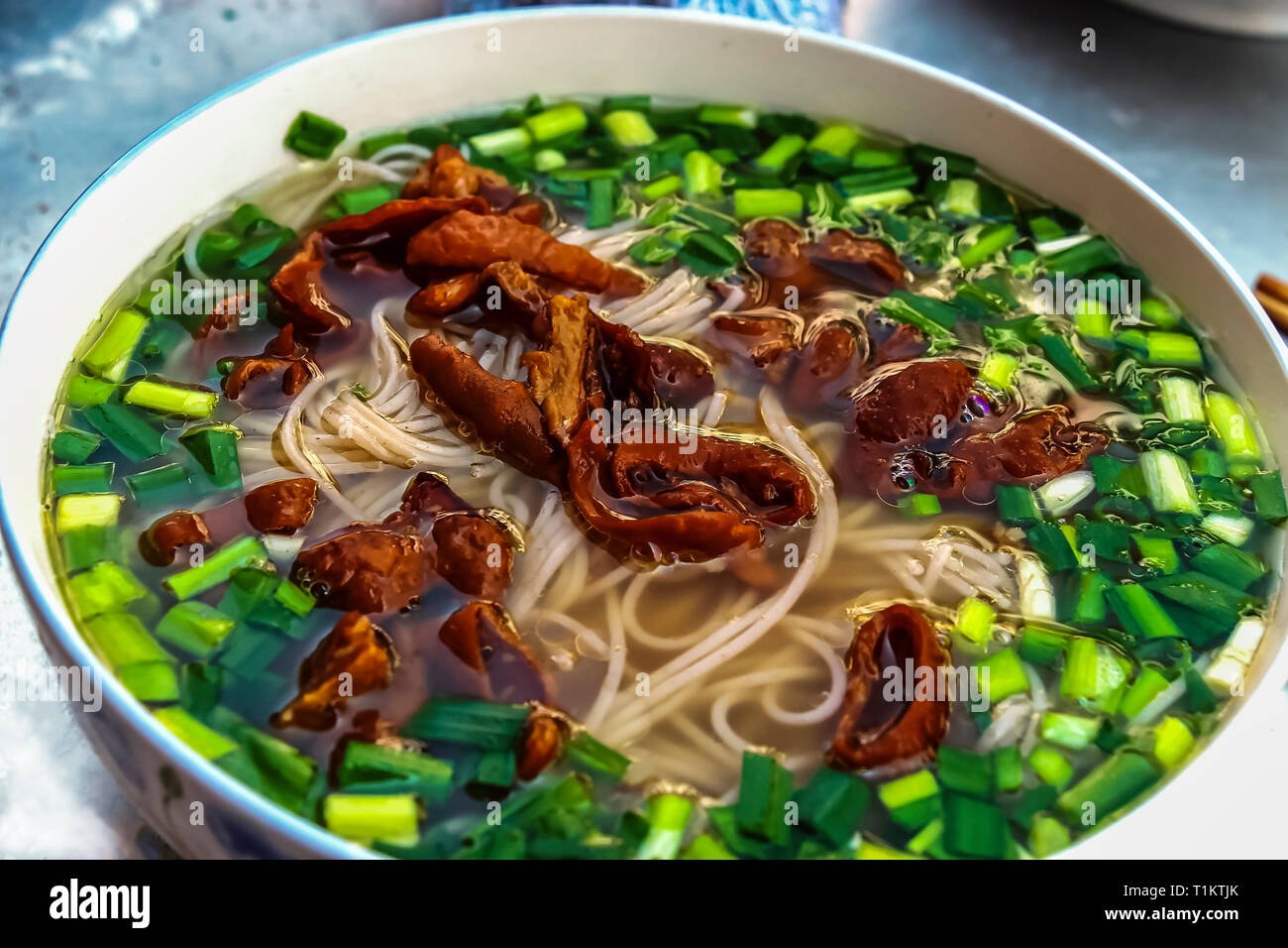 A bowl of hot rice noodle in broth served in the old town in Yuanyang