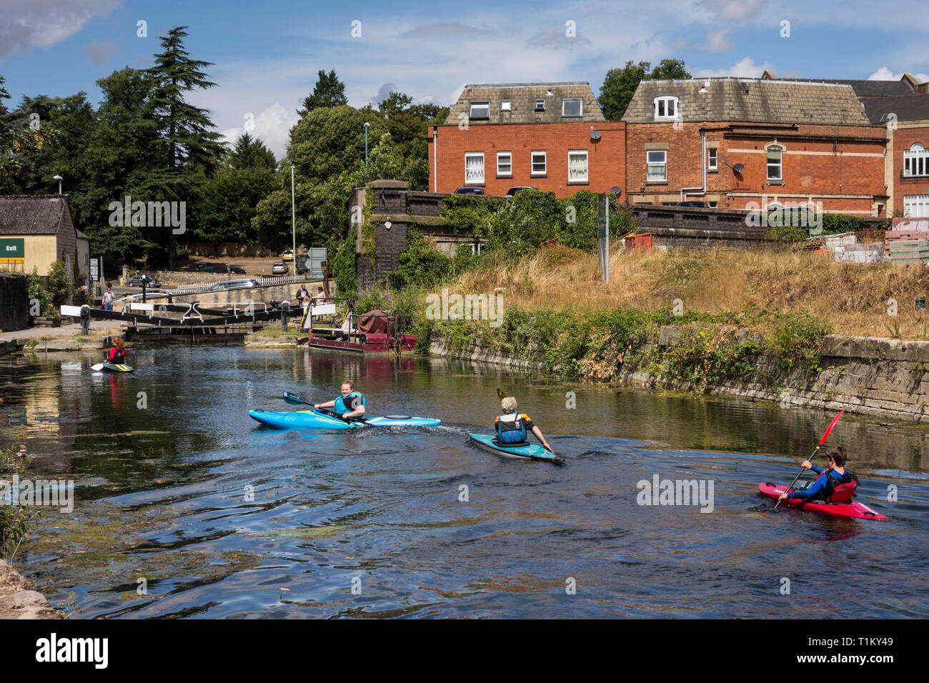 People canoeing in Stroudwater Navigation canal, Gloucestershire, UK
