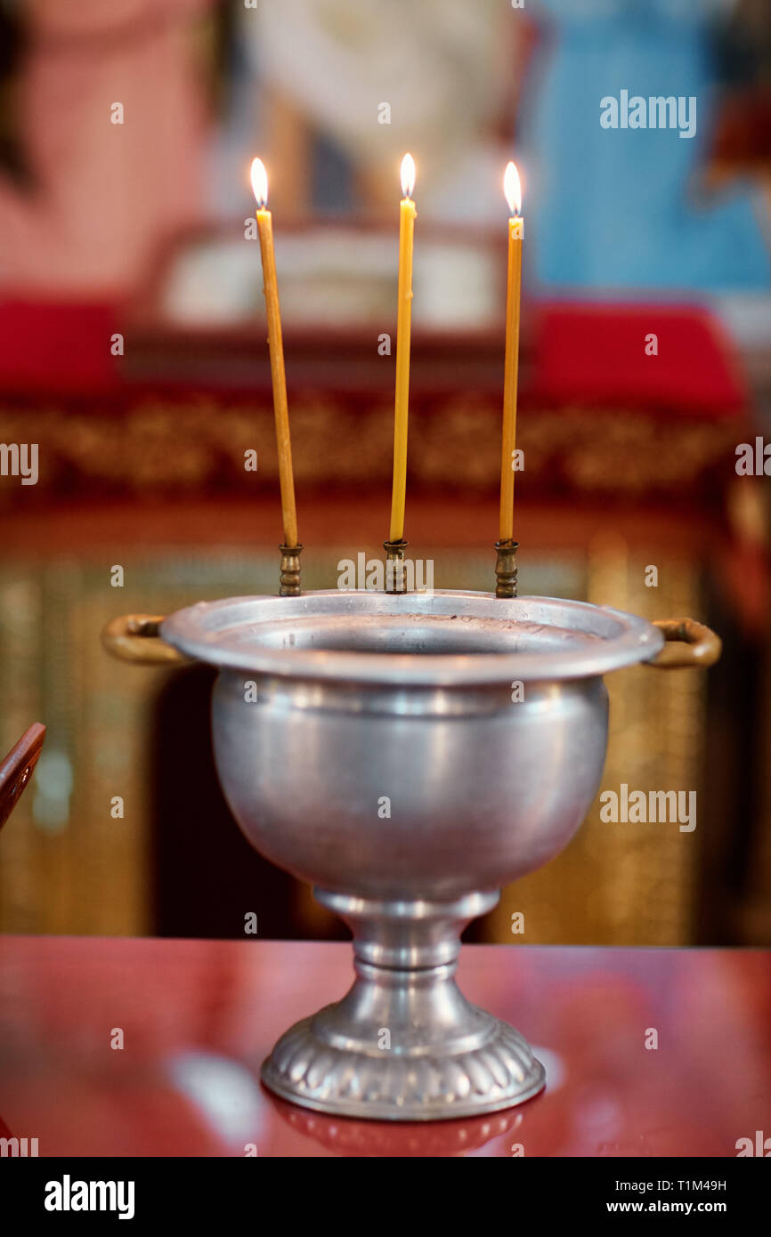 the Church is lit candles and is the rite of baptism of the child Stock
