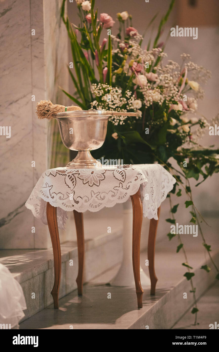 Gold holy water sprinkler in catholic church Stock Photo - Alamy