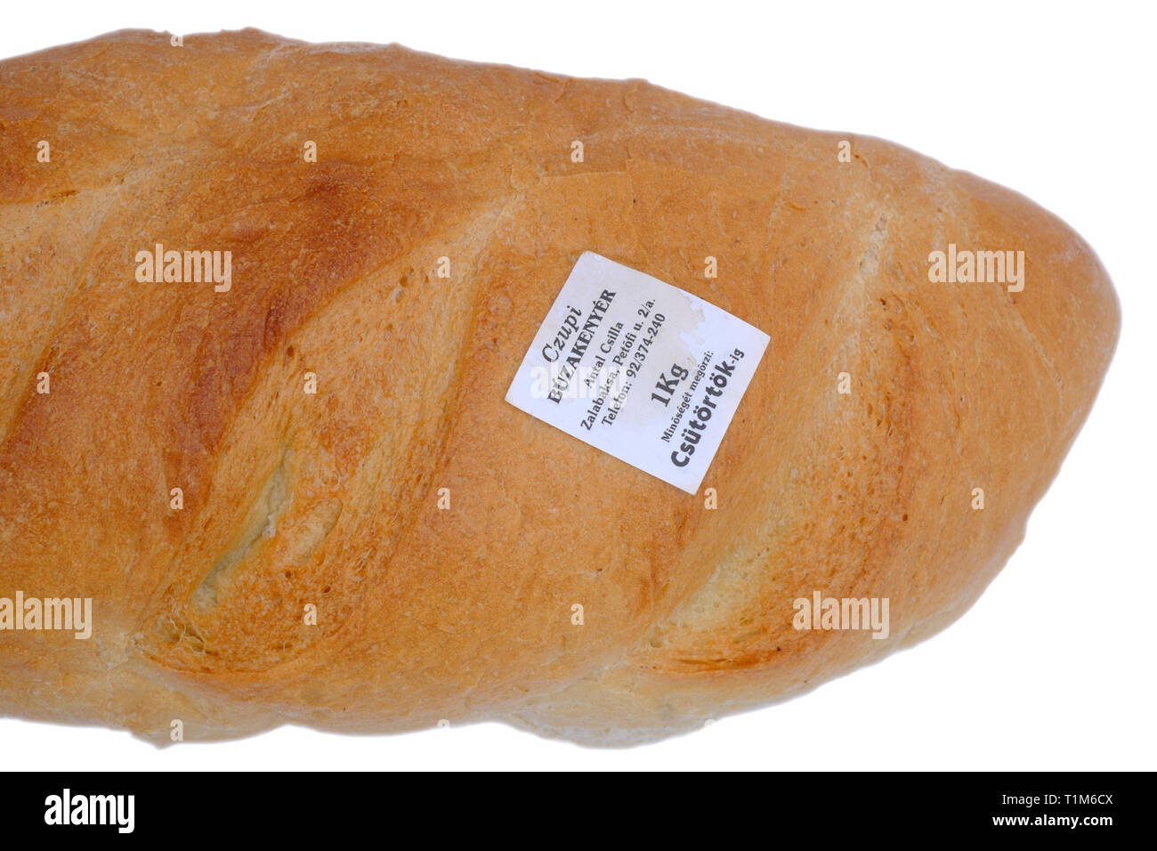 fresh unsliced white loaf with the bakers name label stuck directly