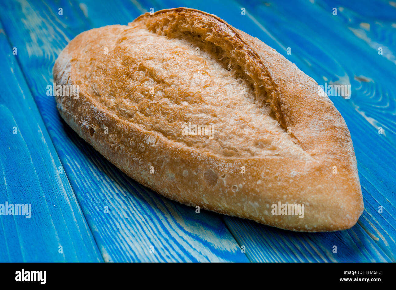Whole loaf bread with crisp on blue wooden background top view Stock ...