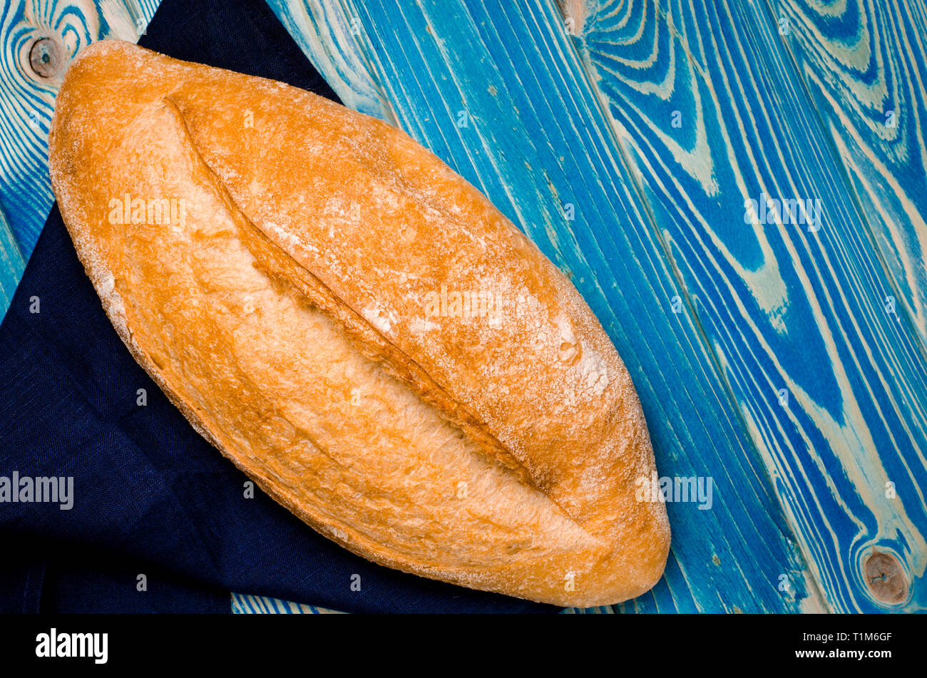 Whole loaf bread with crisp on blue wooden background top view Stock ...