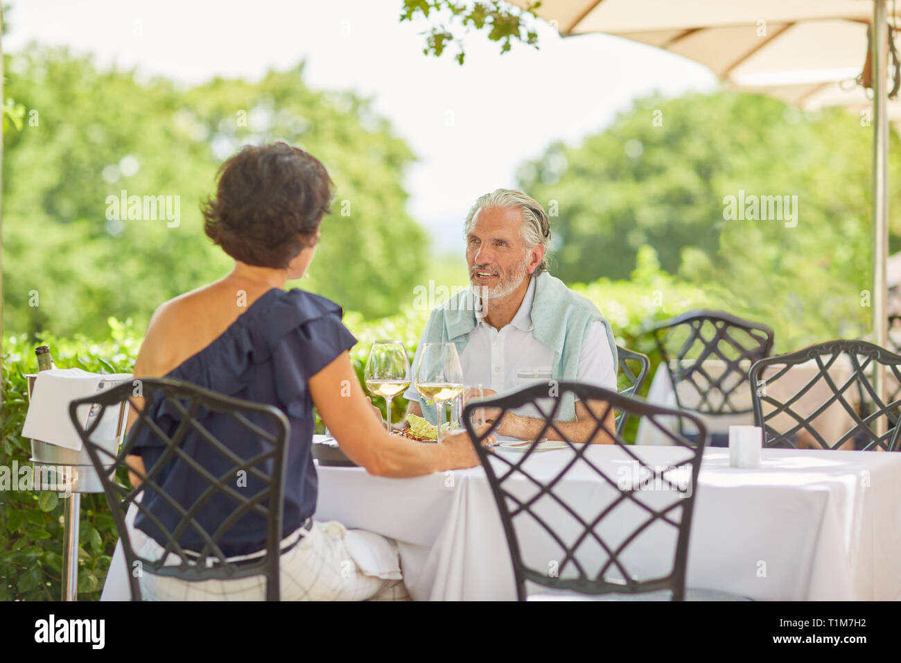 Mature couple dining at patio table Stock Photo