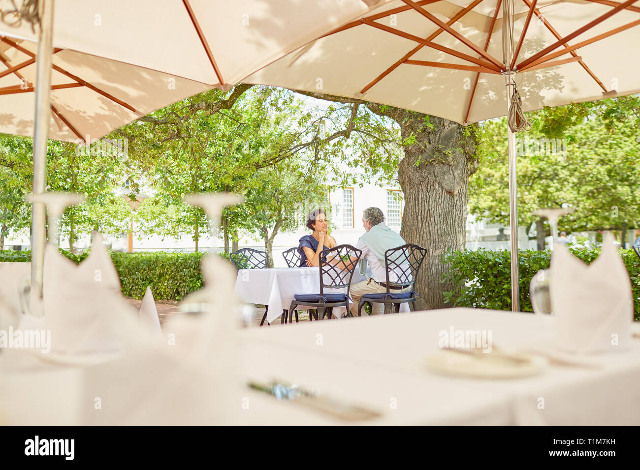 Mature couple dining on resort patio Stock Photo