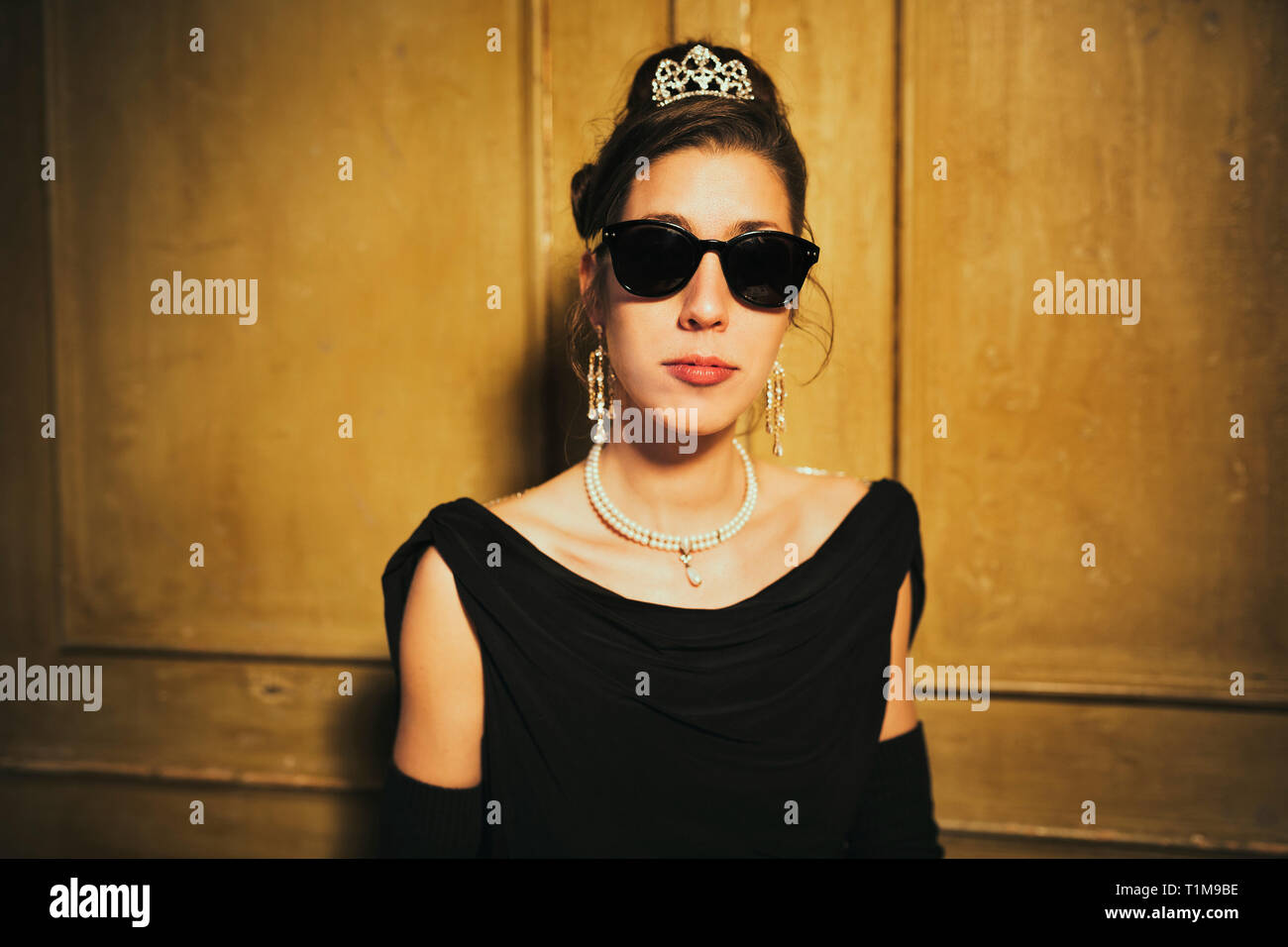 Portrait confident, cool elegant woman wearing sunglasses and tiara Stock Photo