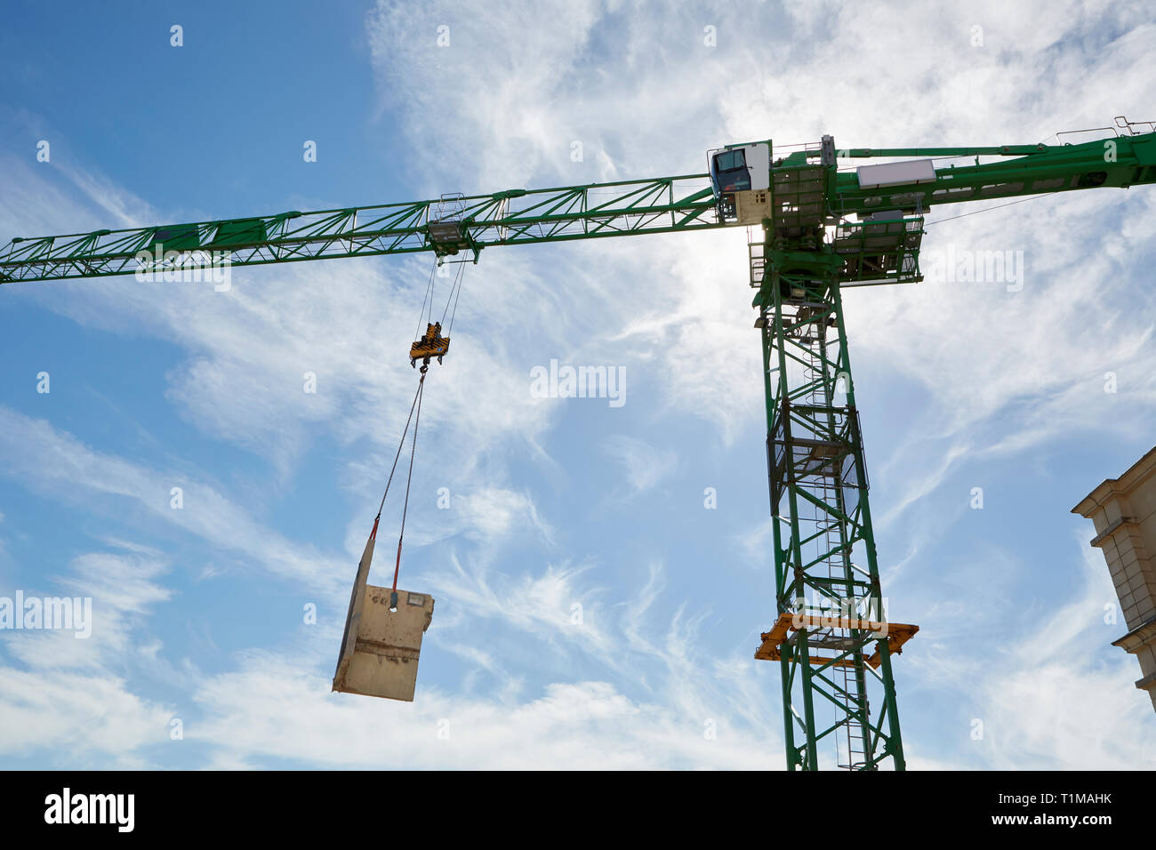 Tower crane lifting construction materials Stock Photo