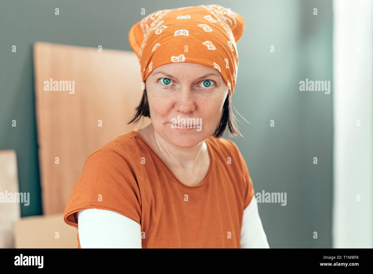 Self employed female carpenter looking at camera portrait in her small business woodwork workshop Stock Photo