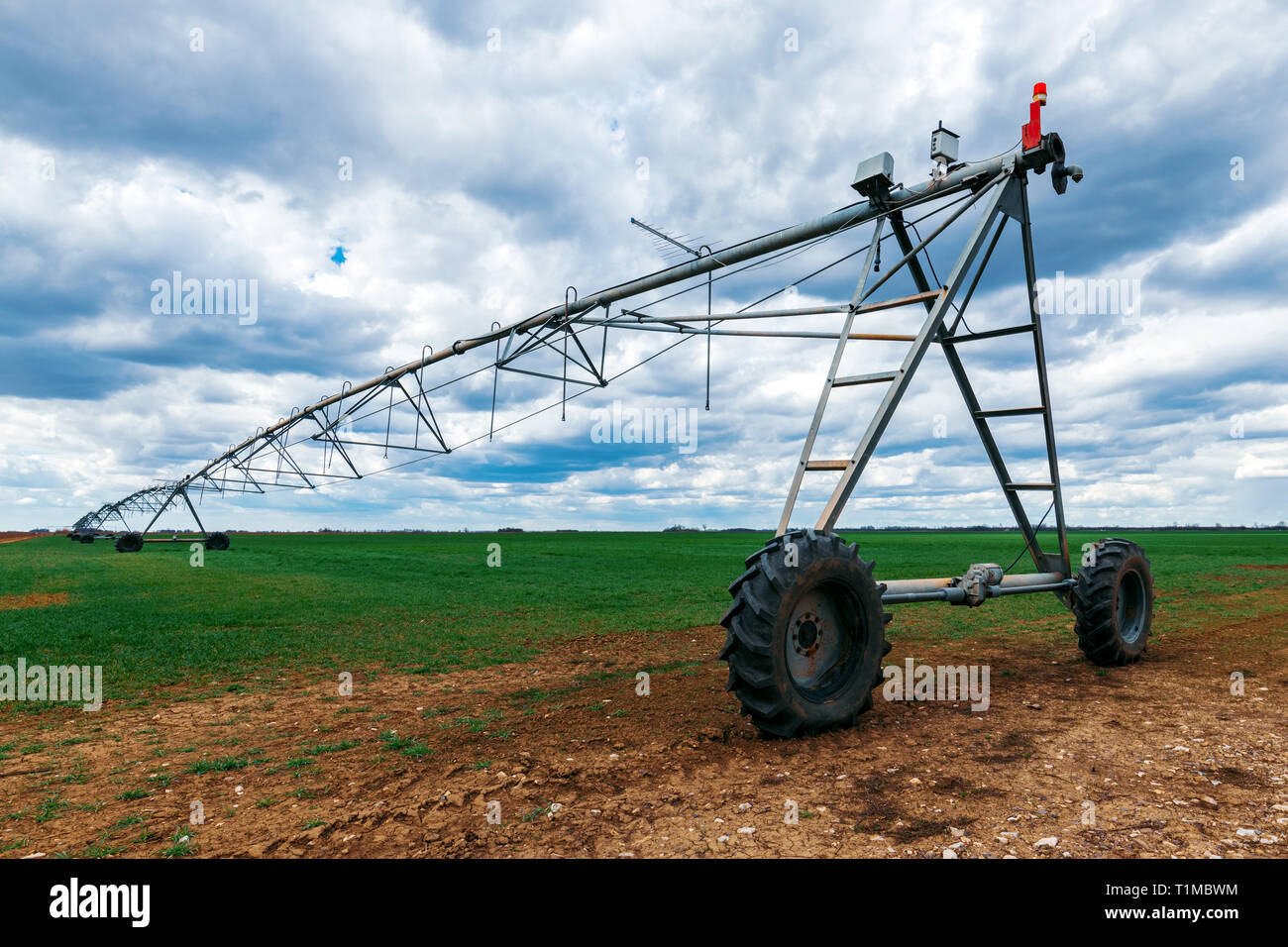 Center pivot irrigation system in cultivated wheat crop agricultural field Stock Photo