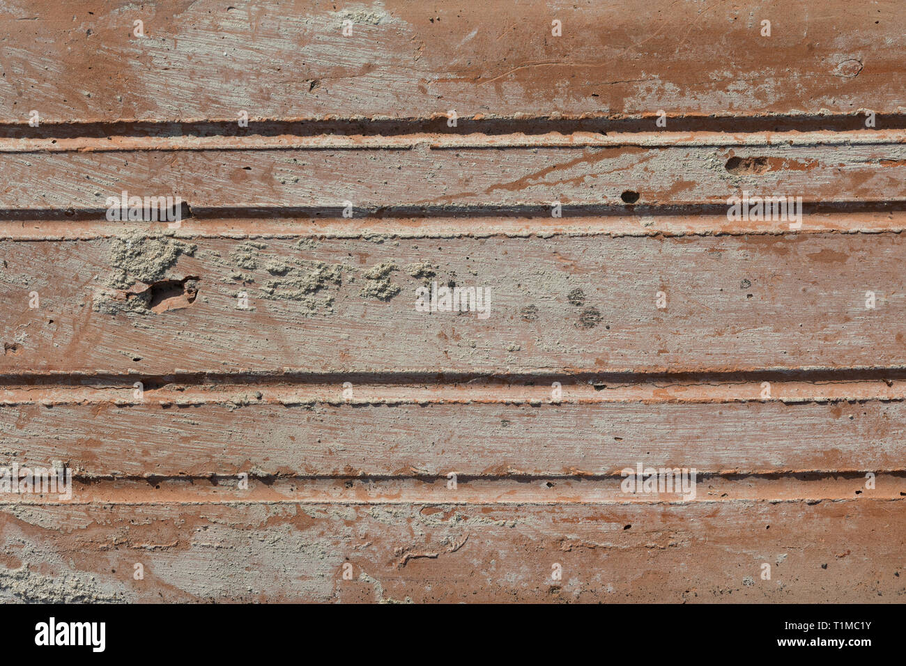 Texture in Close-up Of Old Dirty, Crumbly, Weathered Brick in Harsh Direct Sunlight Stock Photo