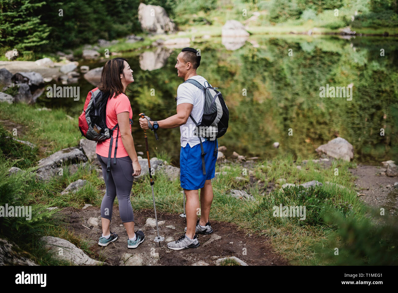 Couple hiking at lake in woods Stock Photo