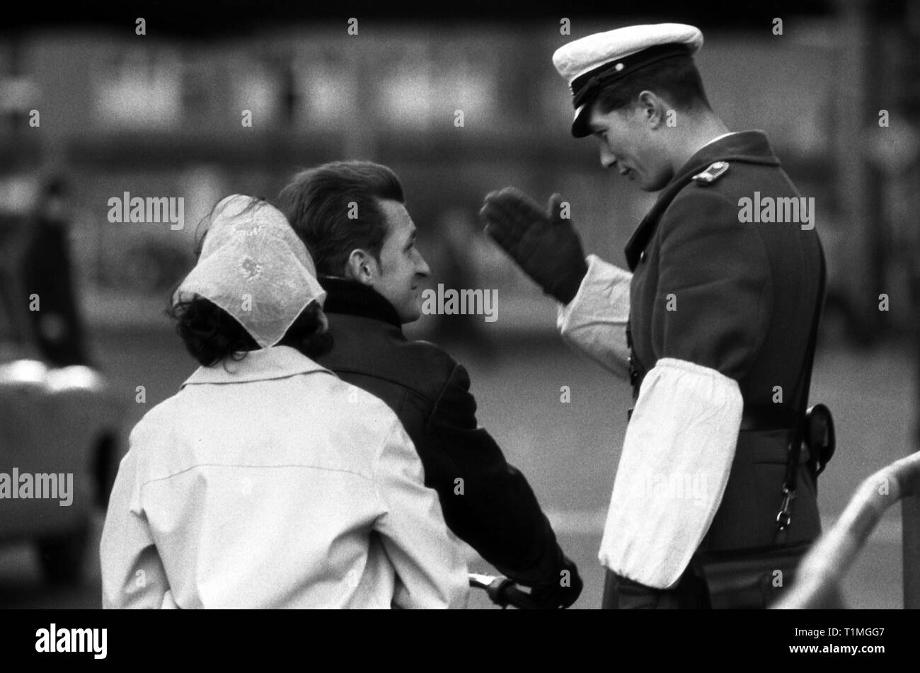 13.11.1965, Berlin, Berlin, GDR - Traffic cop wishes a motorcyclist a good trip. 00S651113A275CAROEX.JPG [MODEL RELEASE: NO, PROPERTY RELEASE: NOT APP Stock Photo