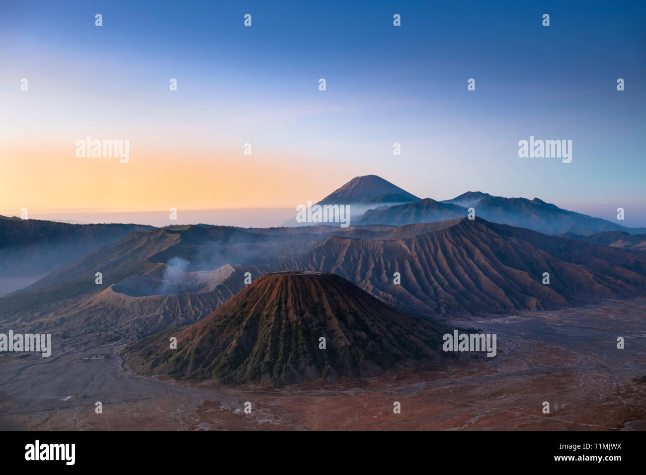 View of the volcanic landscape of Bromo Tengerr Semeru National Park showing the crater of Mount Bromo in the foreground Stock Photo