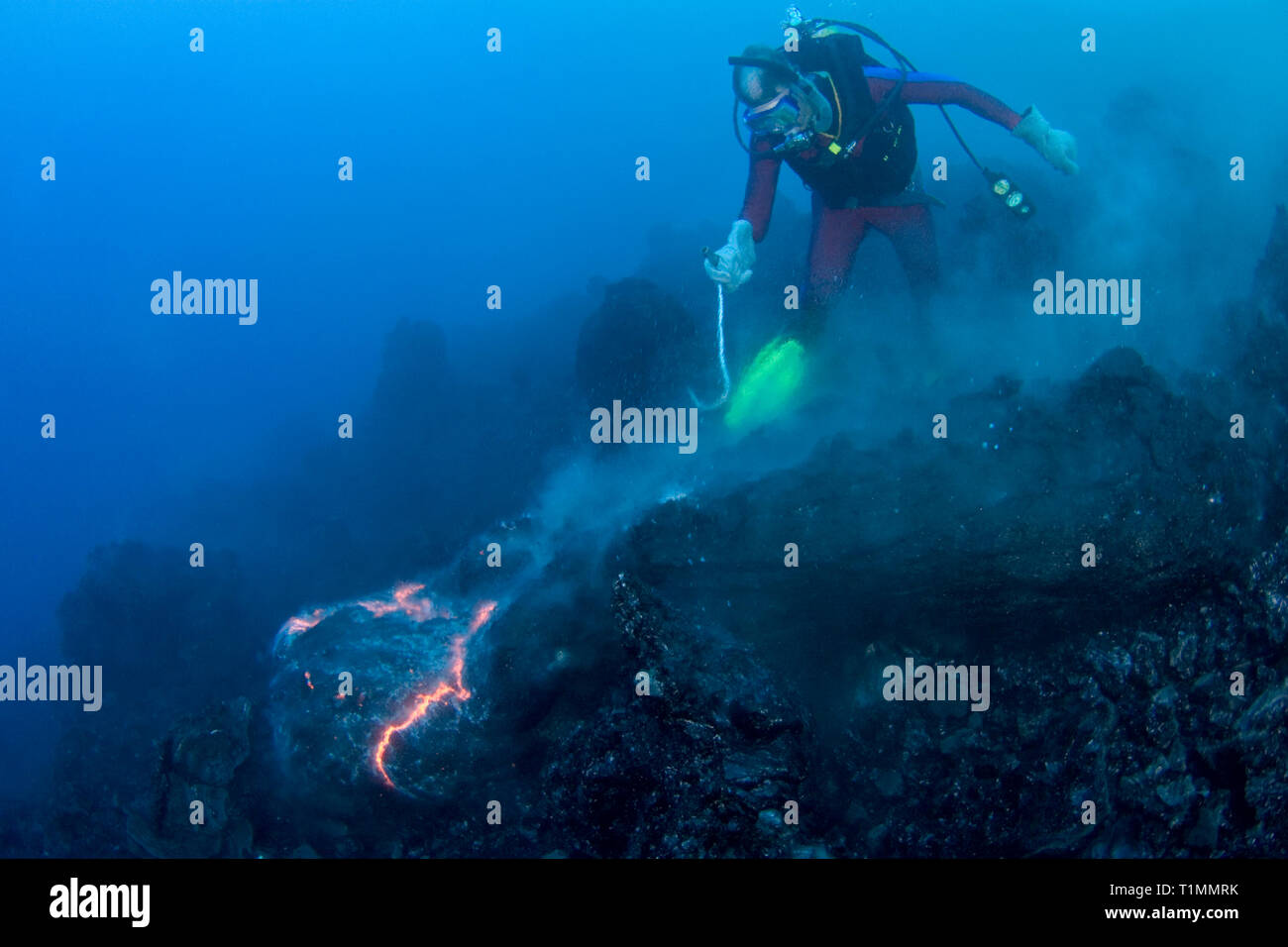 diver Bud Turpin and erupting pillow lava at ocean entry of Kilauea Volcano Hawaii Island ( the Big Island ) Hawaii U.S.A. ( Central Pacific Ocean ) Stock Photo