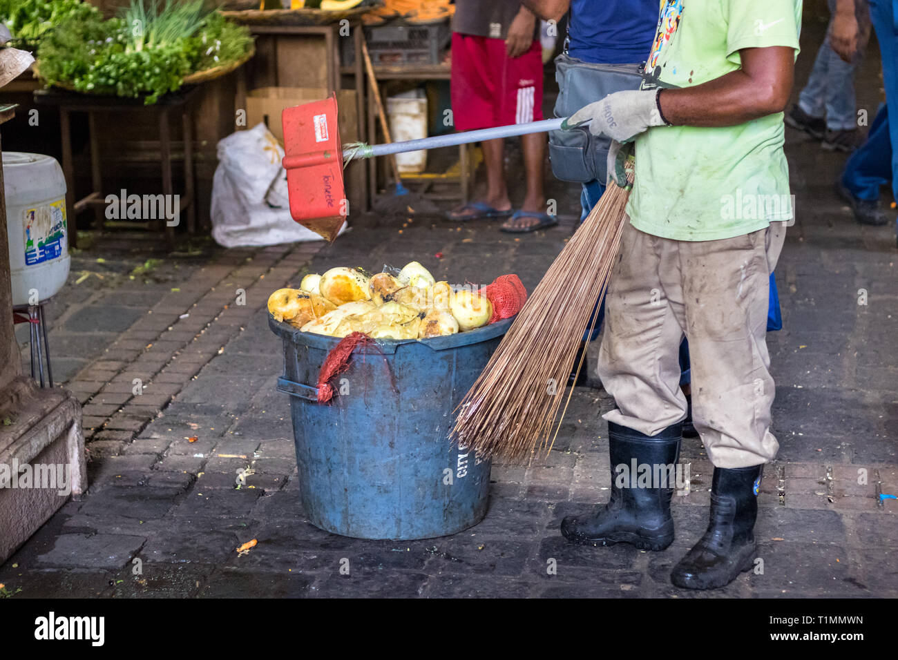 Port Louis, Mauritius - January 29, 2019: A male dustman collecting garbage at the Central Market in Port Louis, Mauritius. Stock Photo