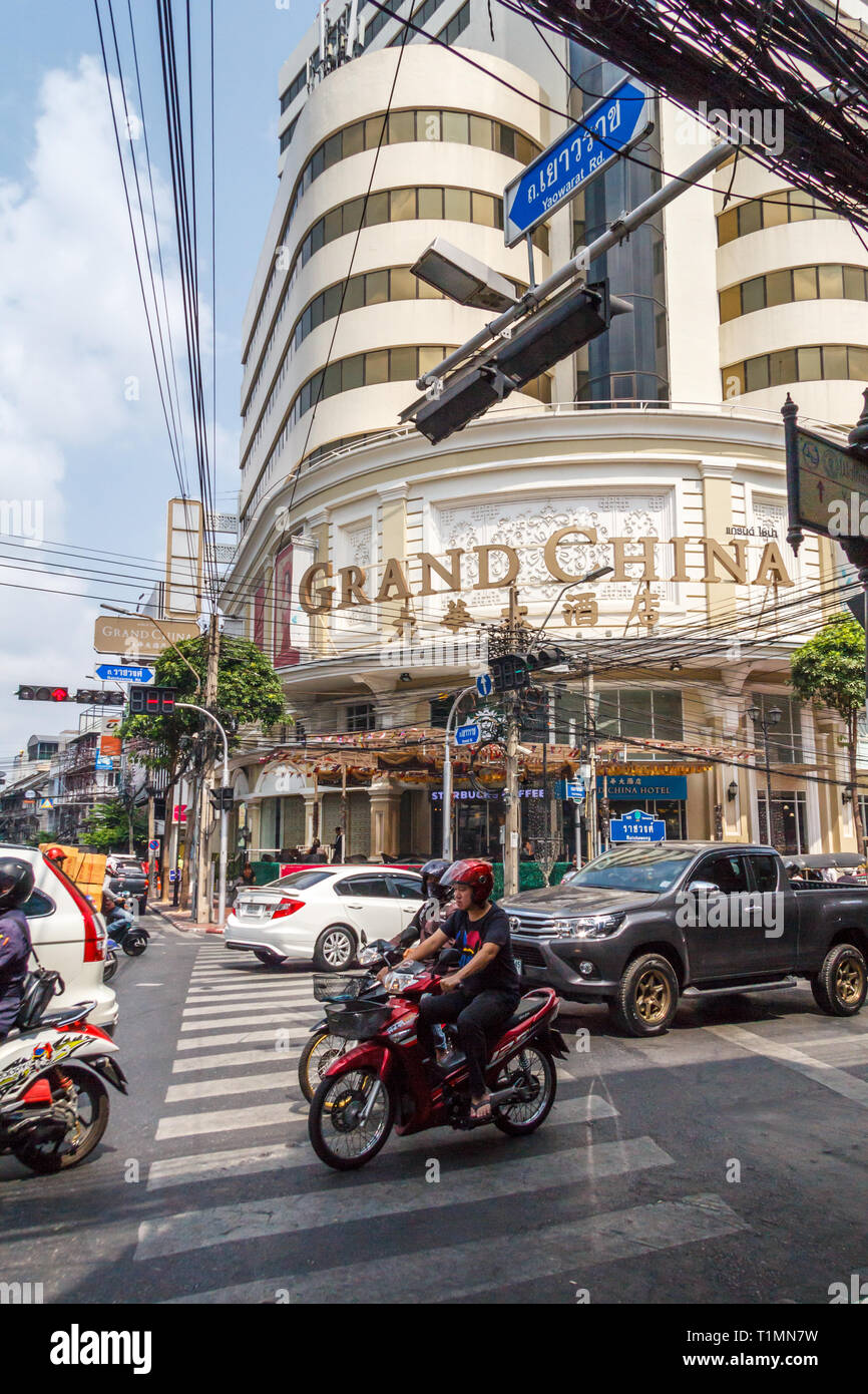 Bangkok, Thailand - 7th March 2017: Traffic passing the Grand China building in Chinatown. The building is both a hotel and a shopping mall. Stock Photo