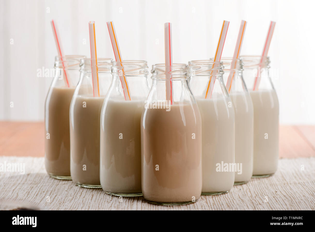 Bottles of milk with straws Stock Photo Alamy