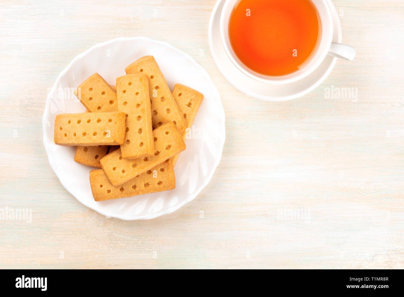 A closeup photo of Scottish shortbread butter cookies, shot from above on a white wooden