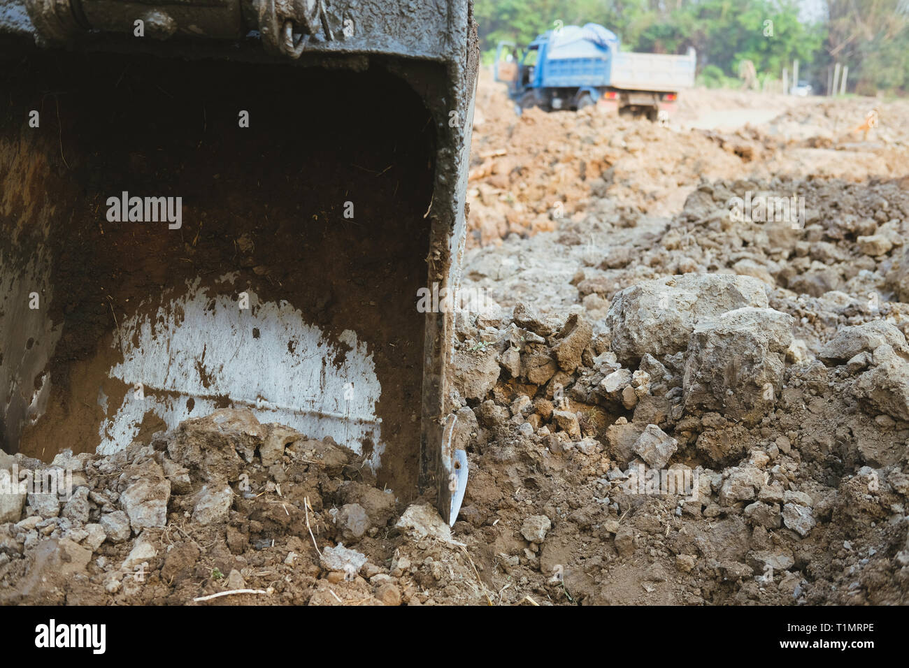 excavator digging making pond. earthmoving work in farmland Stock Photo