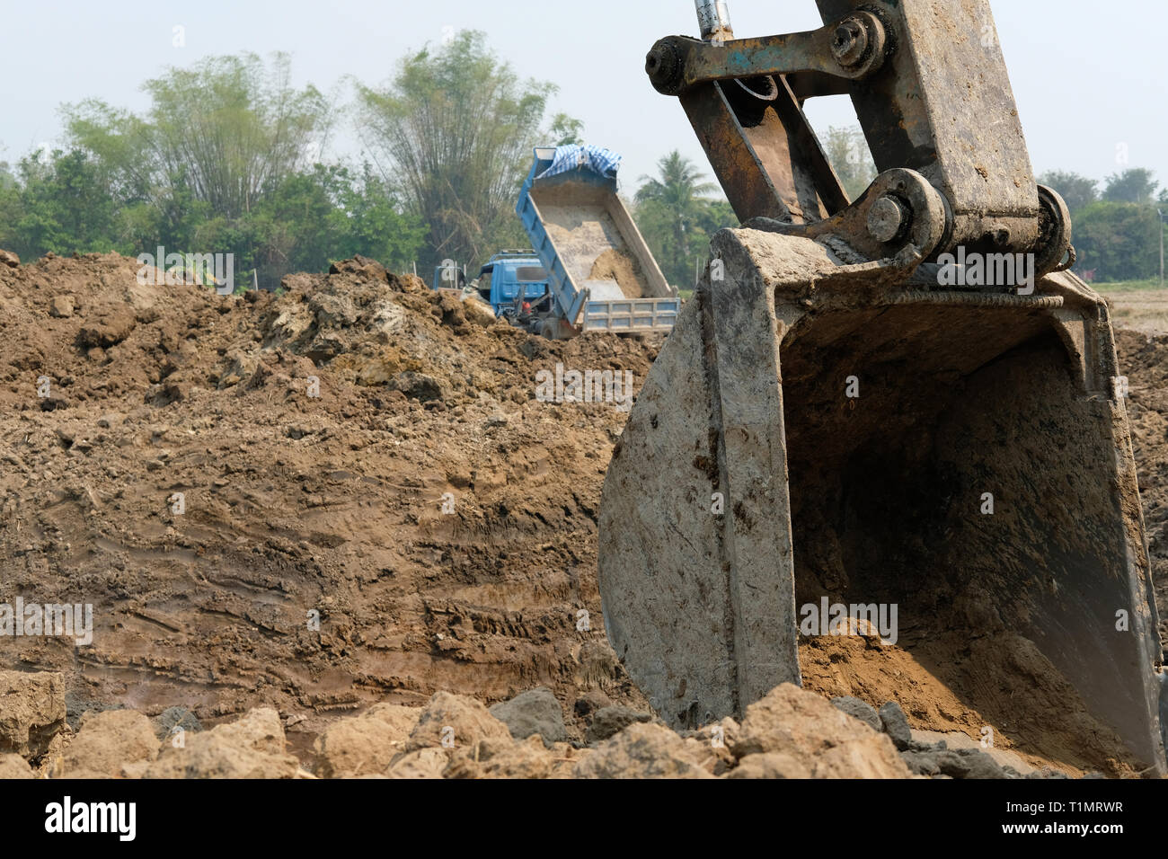 excavator digging making pond. earthmoving work in farmland Stock Photo