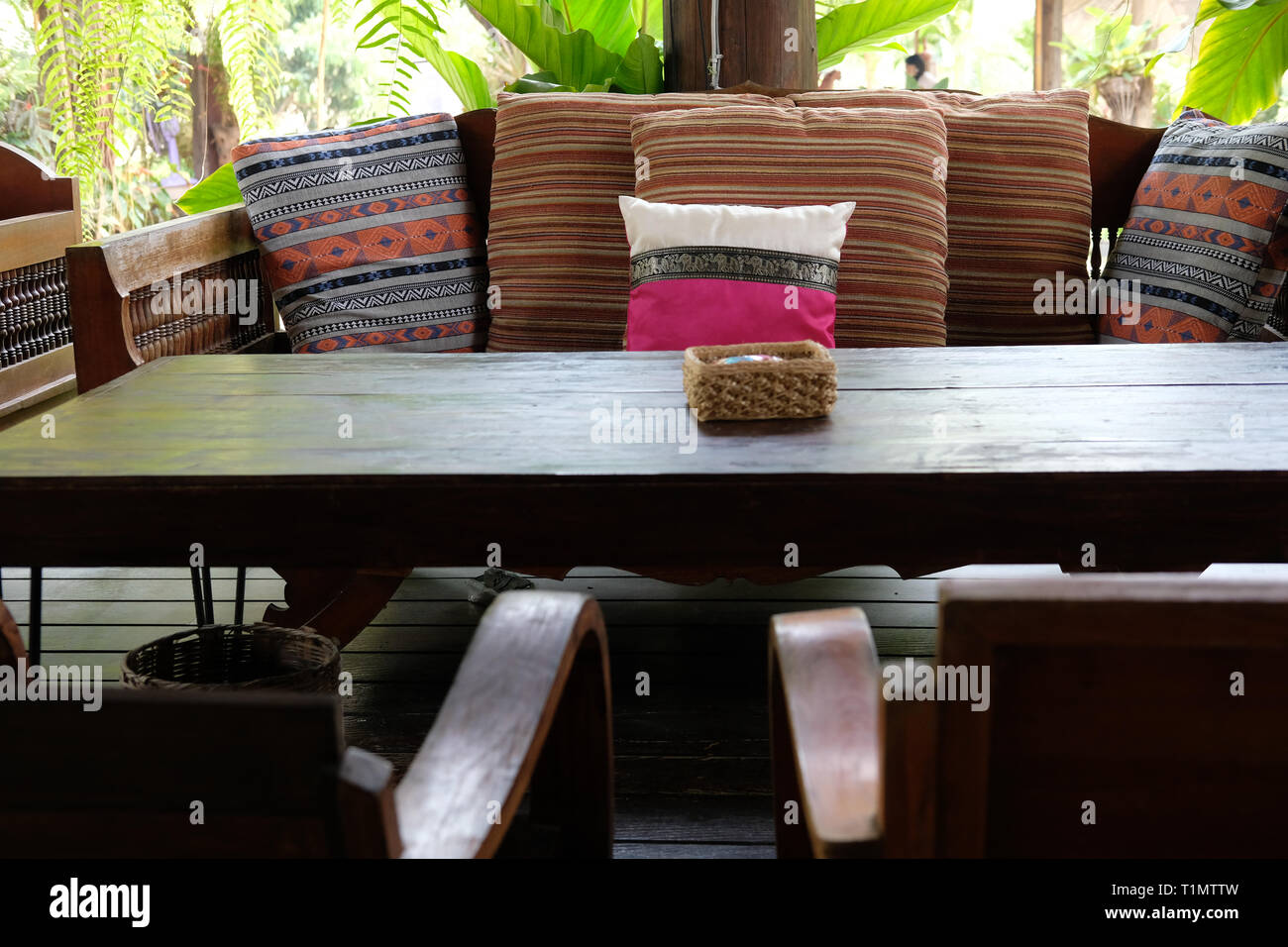 Pink Pillow On Wooden Settee Bench On Terrace Patio Near Garden