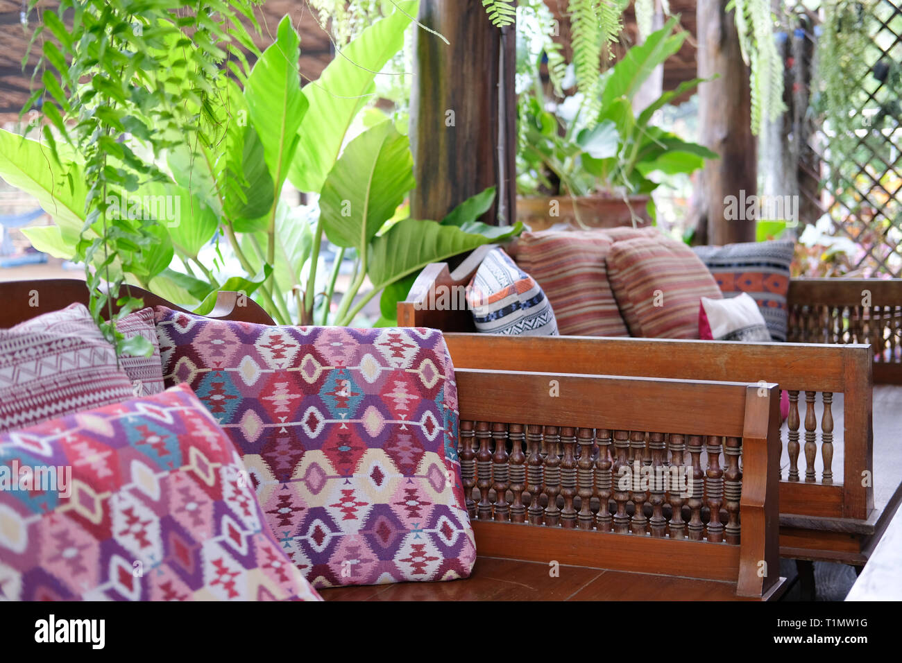 Pink Pillow On Wooden Settee Bench On Terrace Patio Near Garden