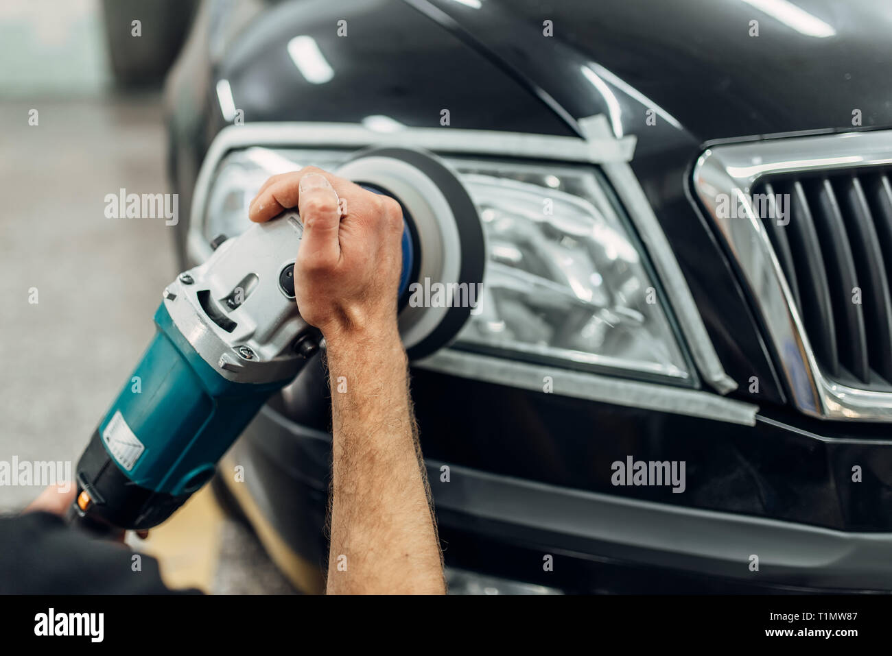 Detailing of car headlights with polishing machine Stock Photo Alamy