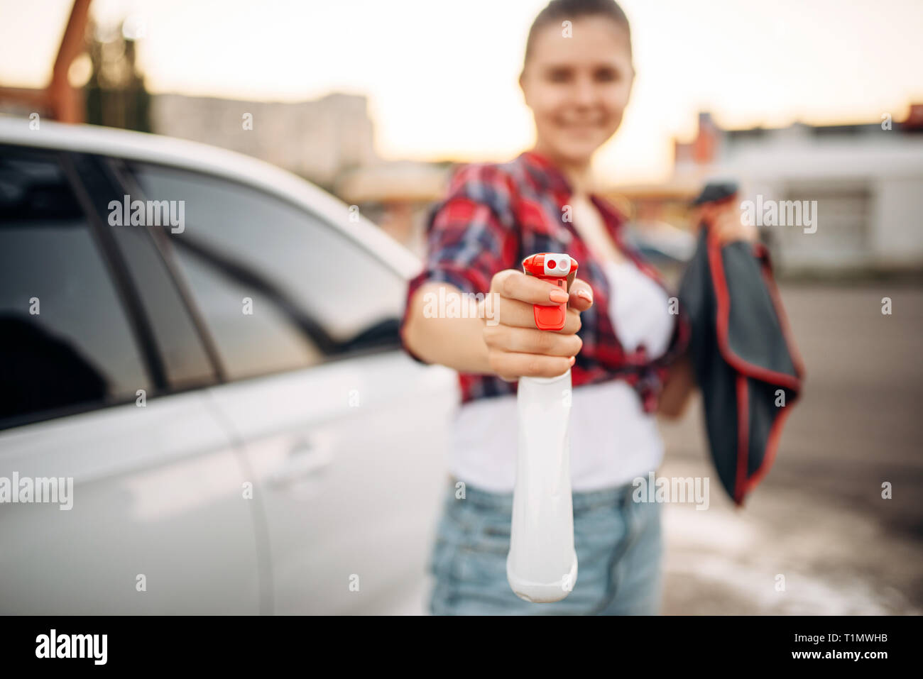 Woman with spray in hand, selfservice car wash Stock Photo Alamy