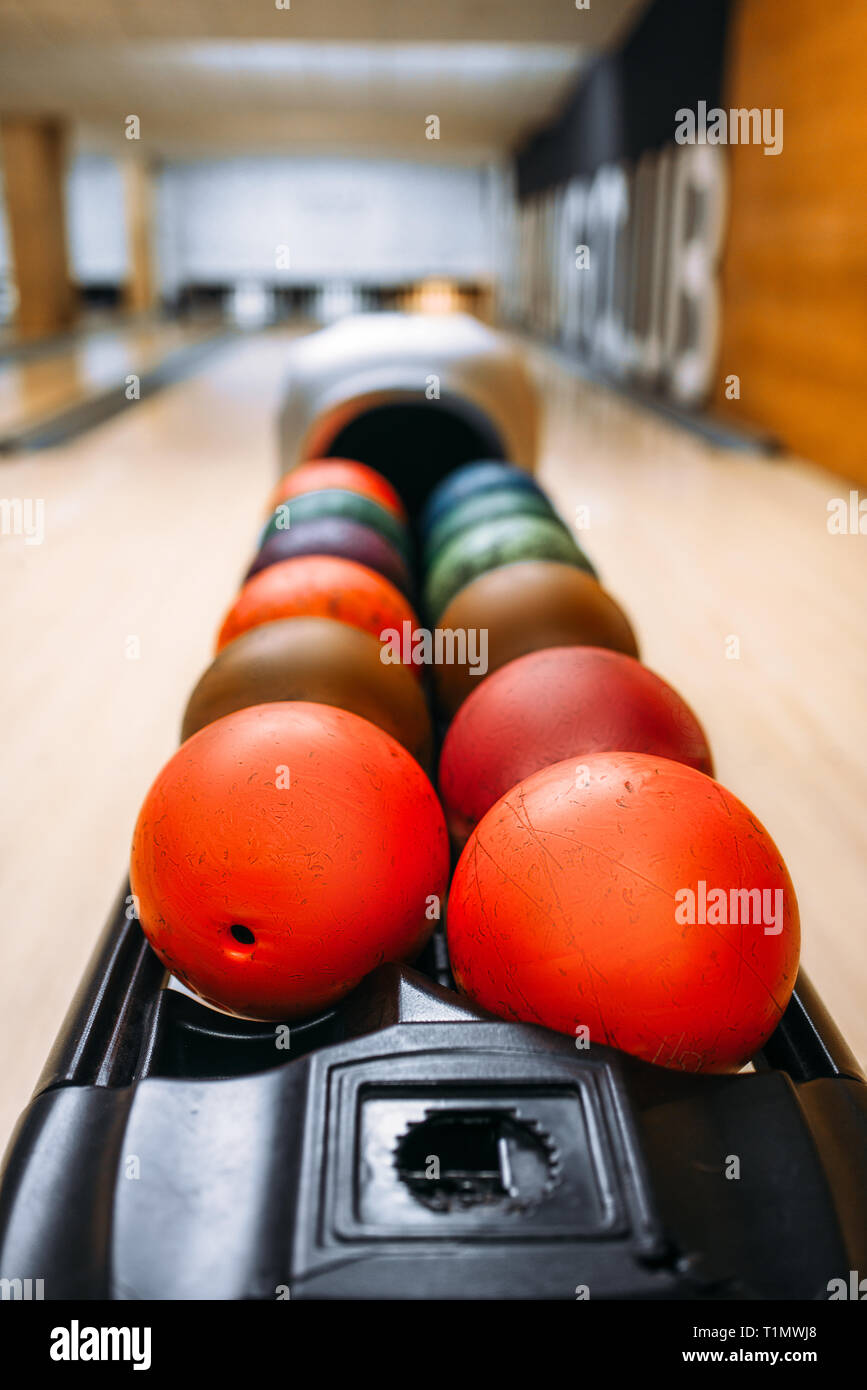 Color bowling balls in feeder, bowl game concept Stock Photo