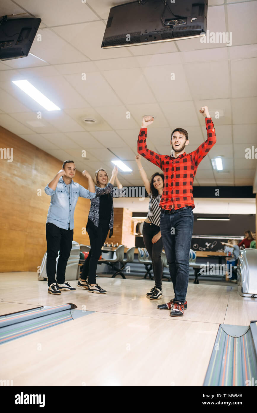 Male bowler cheers, he just makes strike shot Stock Photo