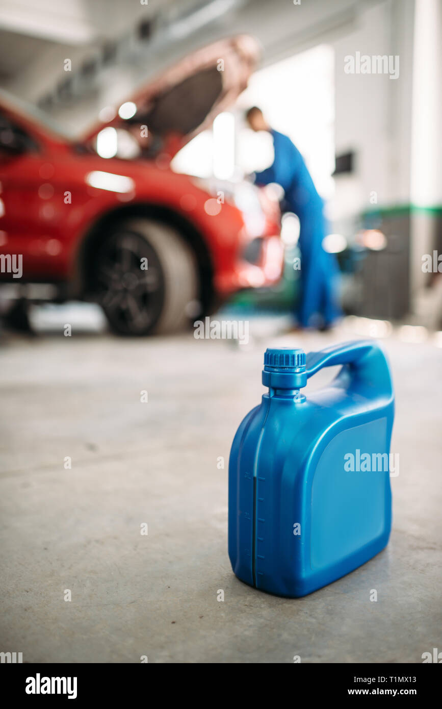 Oil canister on the floor in car service Stock Photo Alamy