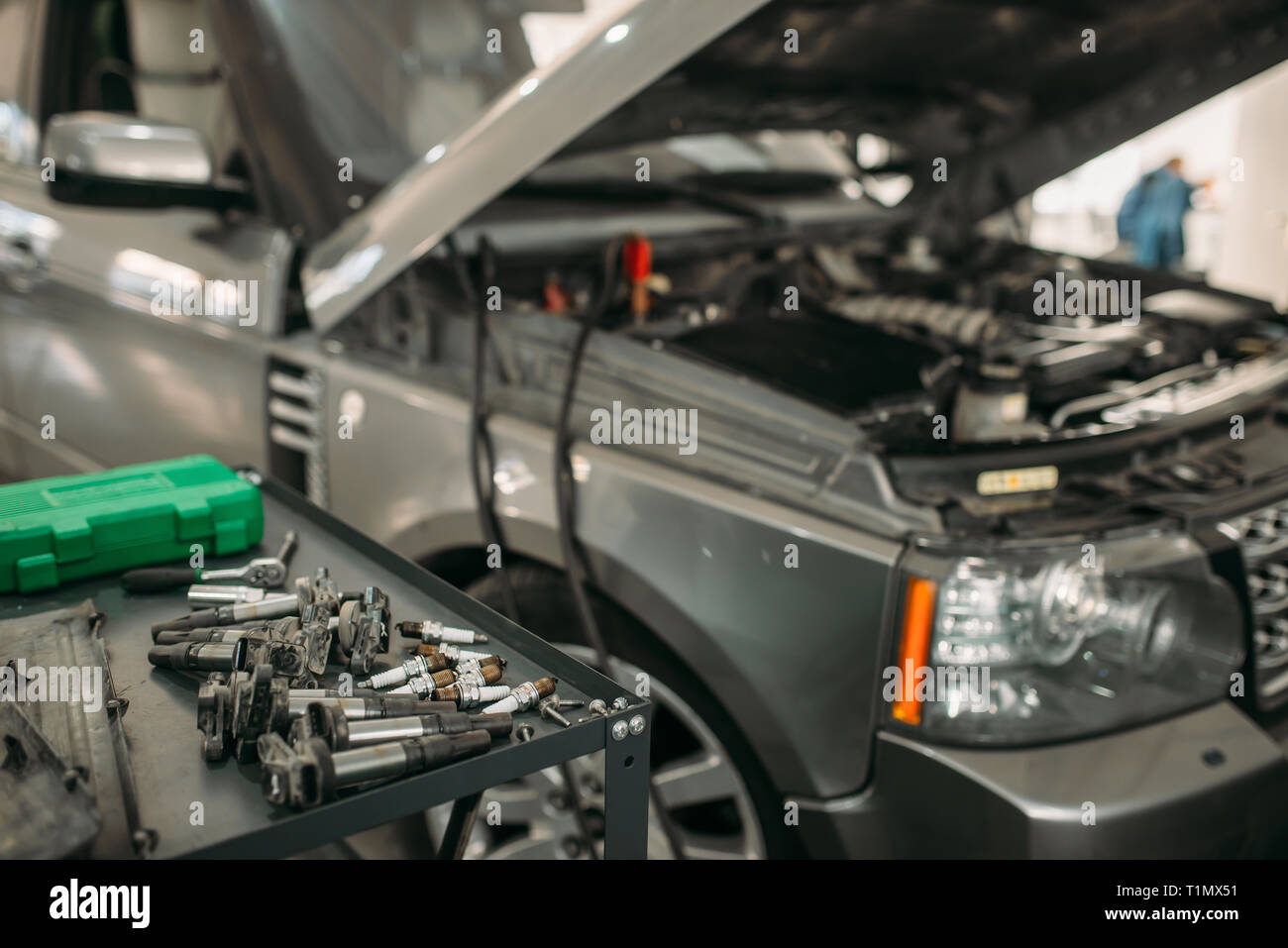Car with opened hood, battery recharging process Stock Photo Alamy