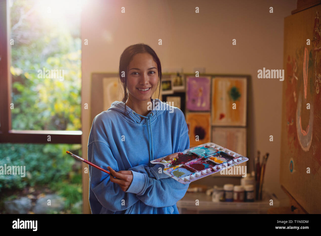 Portrait smiling female artist painting in art studio Stock Photo - Alamy