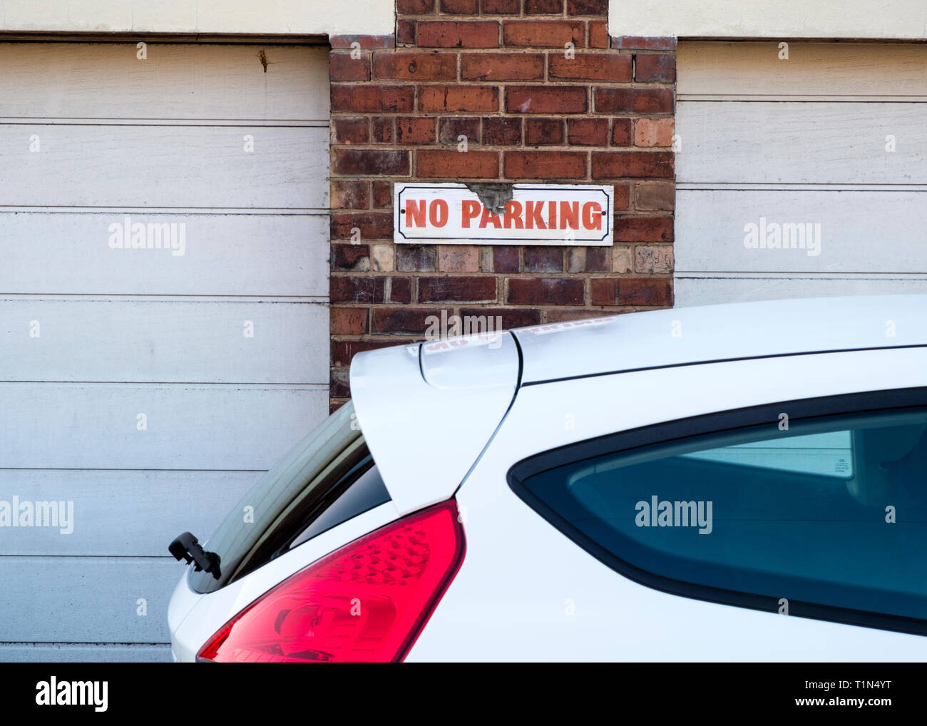 Car parked in front of a No Parking sign, Nottinghamshire, England, UK