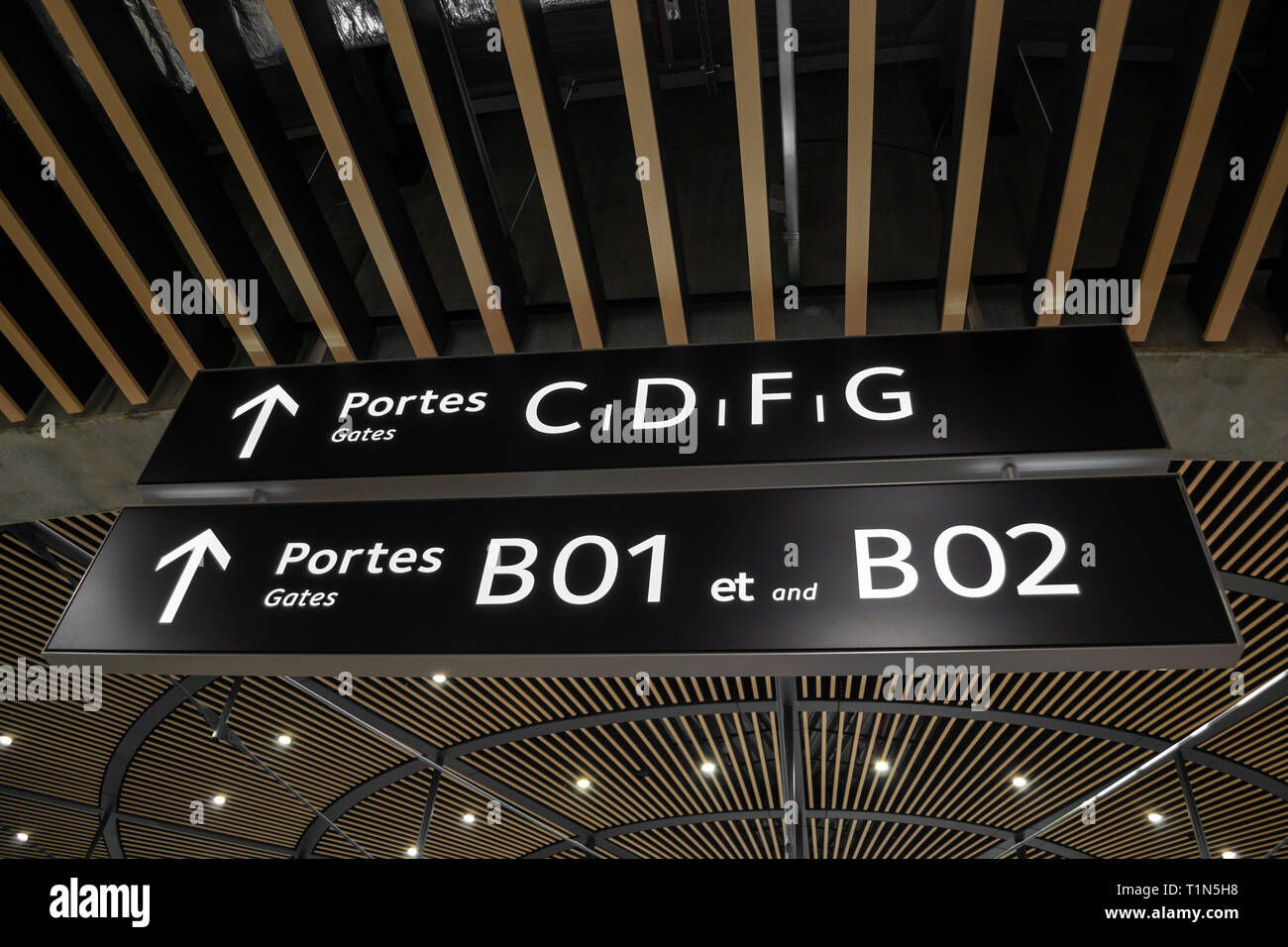 Gates (portes) and arrows signs inside Terminal 1 at Lyon's Saint Exupery International Airport, France. Directional information inside airport termin Stock Photo