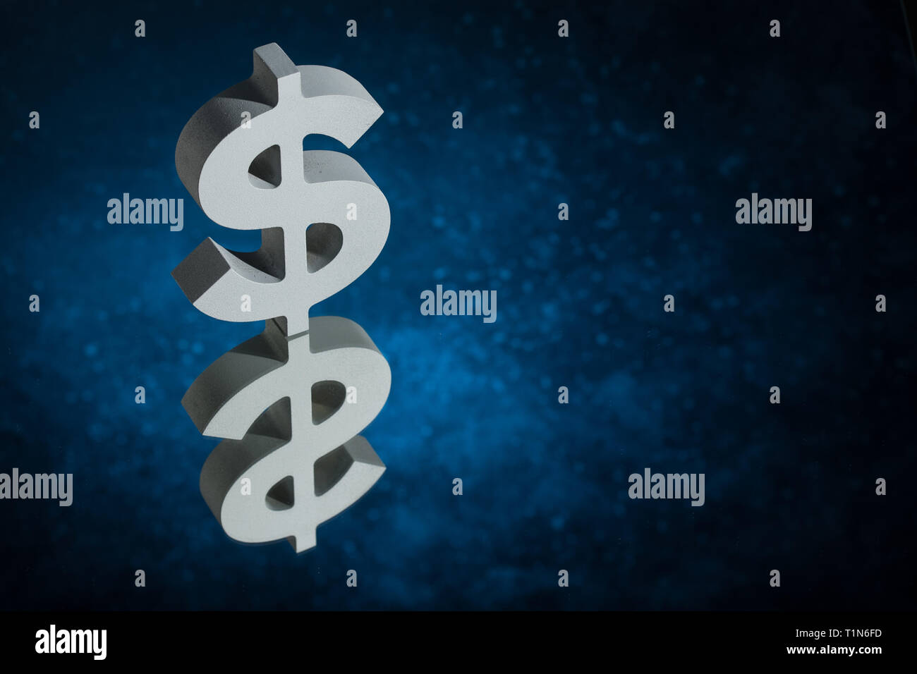 American Currency Symbol or Sign Dollar With Mirror Reflection on Blue Dusty Background Stock Photo