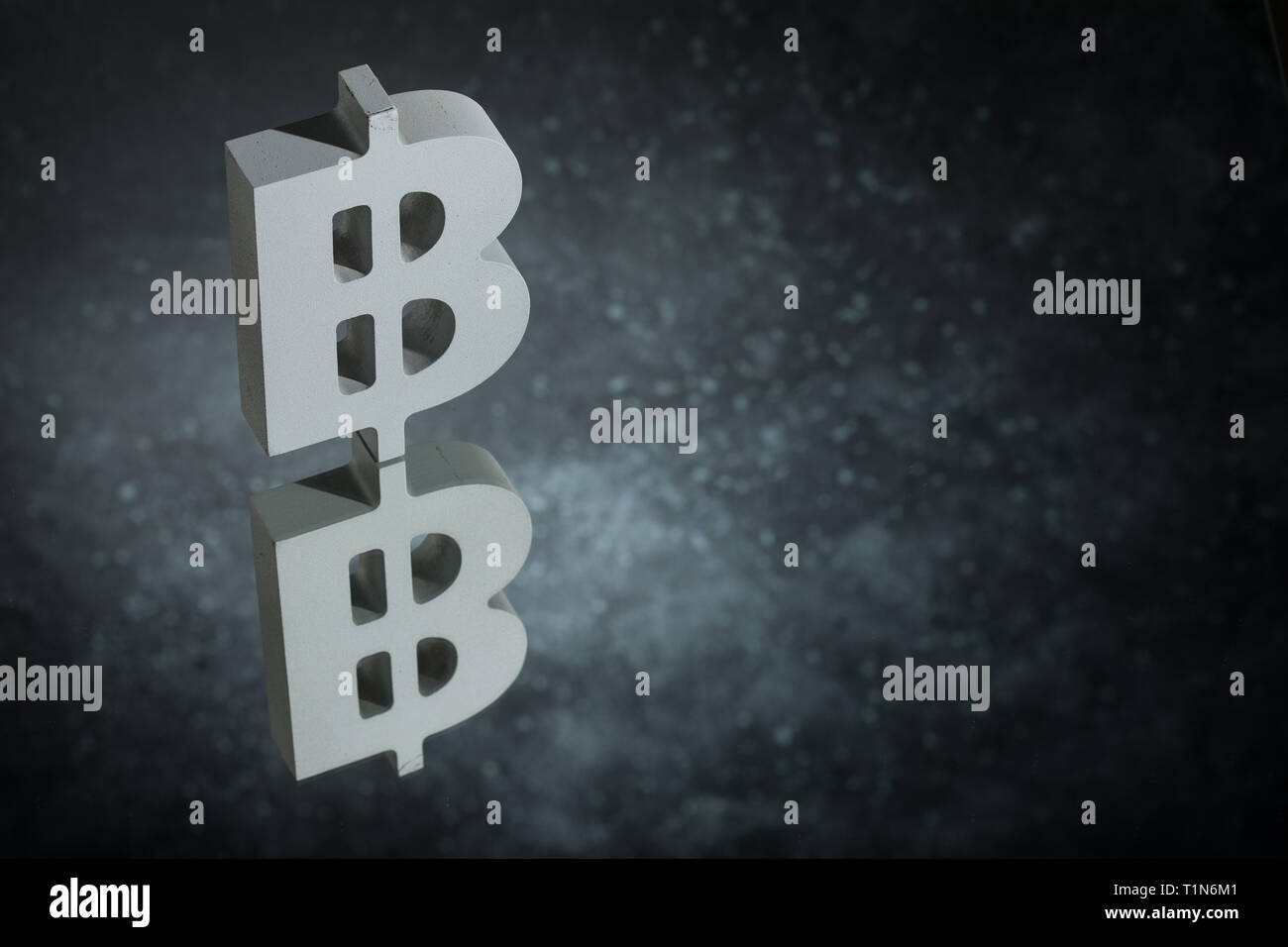 Bitcoin Currency Symbol or Sign With Mirror Reflection on Dark Dusty Background Stock Photo