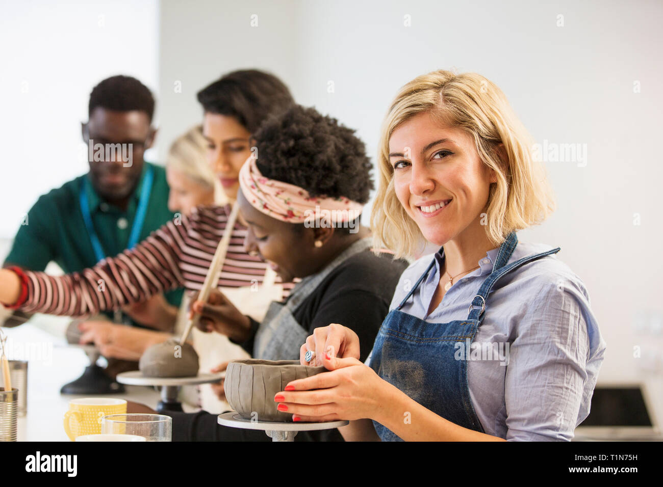 Portrait confident woman making clay bowl in art class Stock Photo