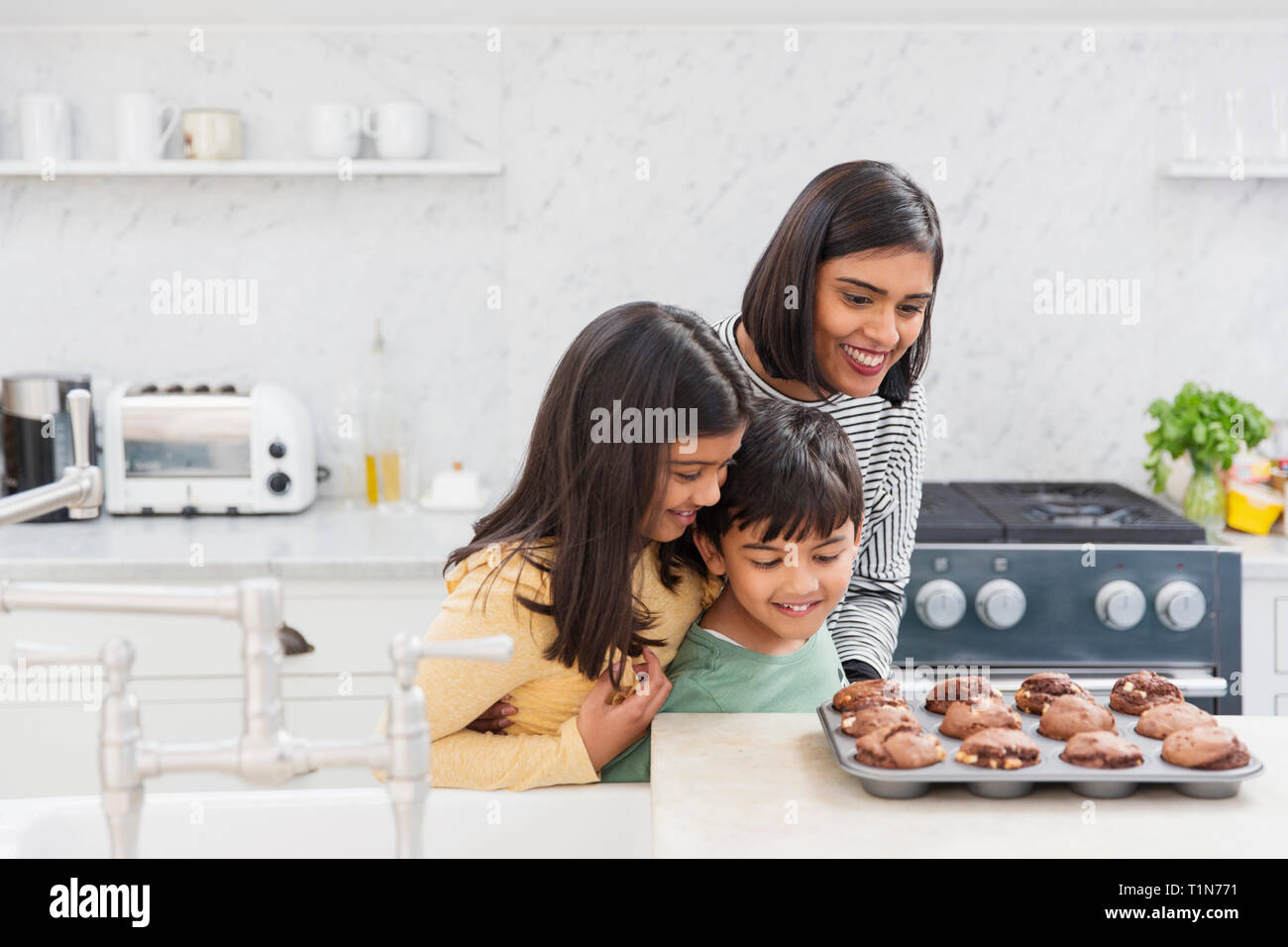 Mother and children baking chocolate muffins Stock Photo