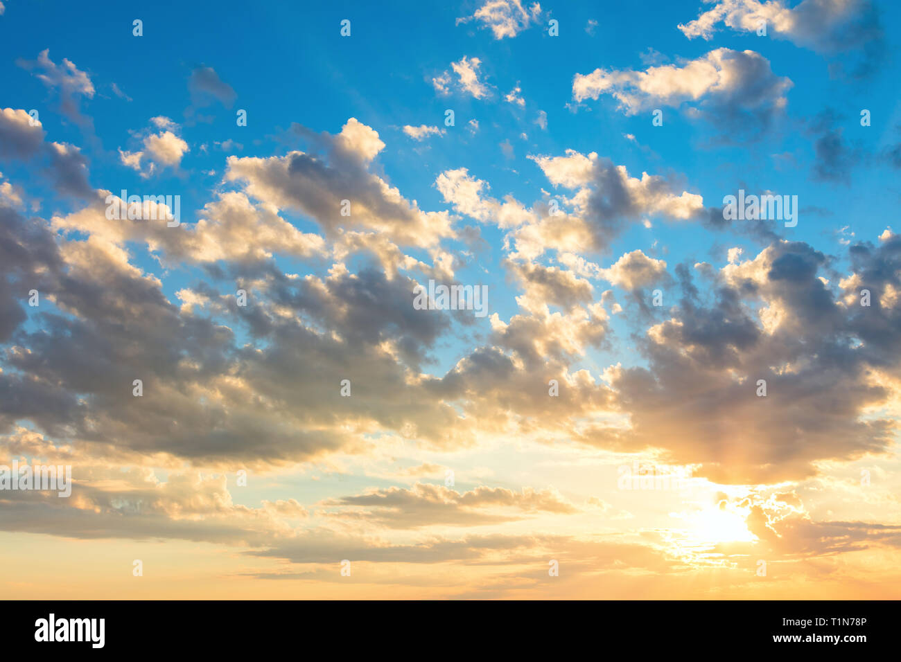 Happy sunrise sky with beautiful light clouds, sun and sunbeams, real Stock Photo