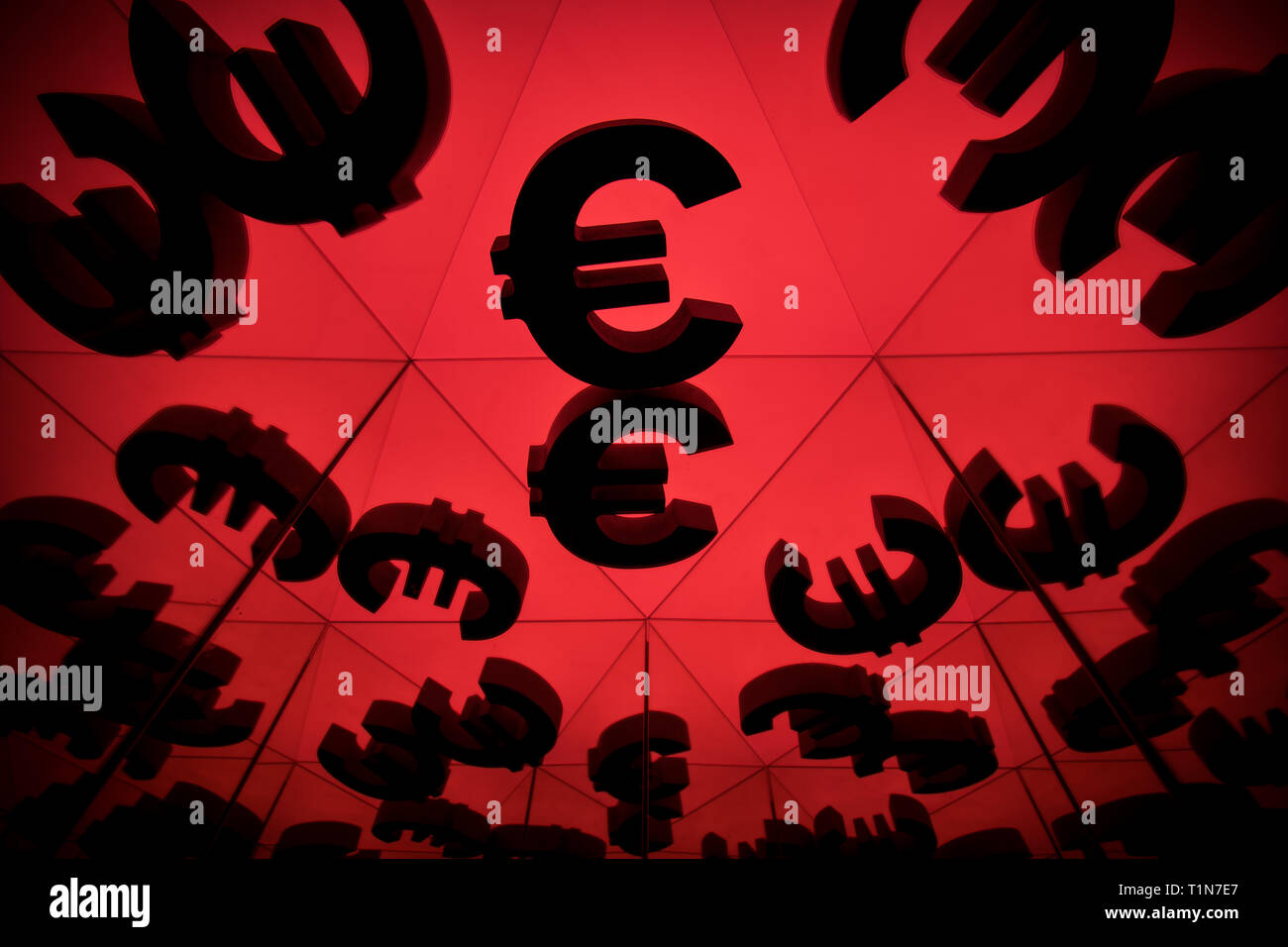 Euro Currency Symbol With Many Mirroring Images of Itself on Red Background Stock Photo